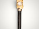 an image of a wooden stick with a clock on top of it