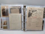 a binder with a lot of old papers inside of it