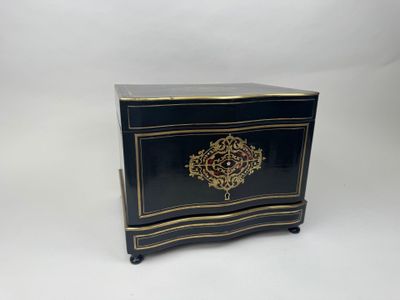 a black and gold chest sitting on top of a white table