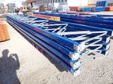 a lot of steel beams that are stacked up on the ground