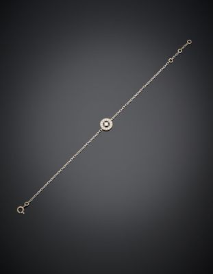 un bracelet en or orné d'un œil maléfique sur fond noir