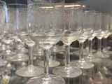 many wine glasses sitting on a glass table