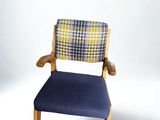 a chair with a blue seat and a yellow and white checkered back