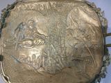 a silver box with a picture of a man riding a horse on it