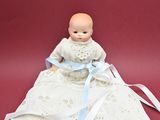 a small doll that is sitting on a red surface