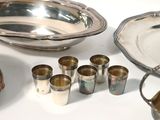 a table with a lot of silver items on it