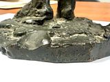 a statue of a man riding a horse on top of a rock