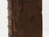 an old book sitting on top of a white table