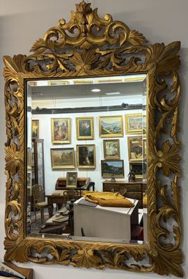 a mirror on the wall above a desk in a room