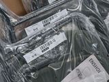a pile of luggage that is wrapped in plastic