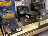 a display case filled with various toy cars and other items