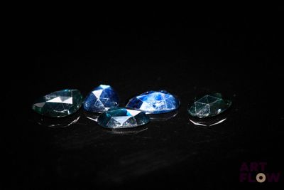 a group of blue and white diamonds on a black surface