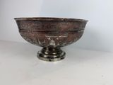 a large silver bowl with ornate designs on it