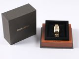 a box with a watch inside of it on a white surface
