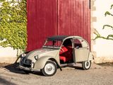 a small car that is parked in front of a red door