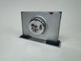 a silver clock on a metal stand on a white surface