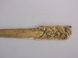 a gold spoon with a picture of a man and a woman on it
