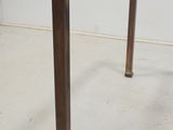 a small table with a glass top on the floor