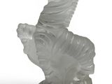 a glass figurine of a horse on a pedestal