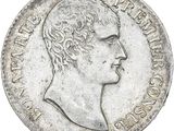 a close up of a coin with a man ' s face on it