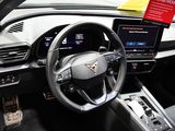 a steering wheel and dashboard of a car with a red sticker on it