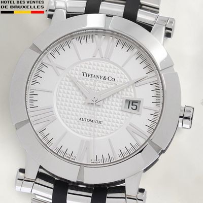 a close up of a watch on a white surface