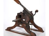 an old wooden machine with a wooden handle on a white background