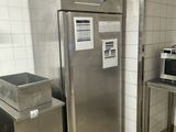 a refrigerator and a microwave in a small kitchen