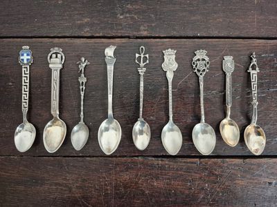 several spoons and spoon spoons are lined up on a wooden surface
