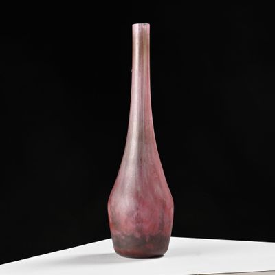 a pink glass vase sitting on a white table
