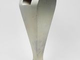silver metal sculpture of a heart shaped vase on a white background