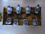 many figurines of men sitting in a small boat