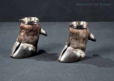 two silver cups with a bear ' s paw design on them