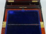 an old wooden box with a blue velvet lining inside