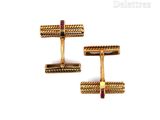 two pairs of gold and ruby cufflinks on a white background