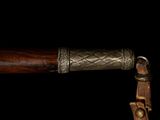a close up of a wooden handle on a cane