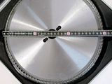 a picture of a circular metal object with a ruler on it