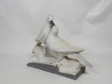 a white bird that is sitting on top of a table