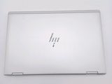 the back of a white laptop computer sitting on top of a white table