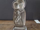 a statue of a woman holding a baby on a table
