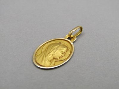 a close up of a gold medal with a woman ' s face on it