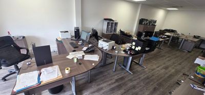 an image of an office with a lot of desks and chairs