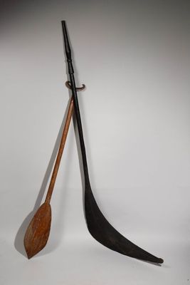 pair of wooden paddles and a wooden paddle on a white surface