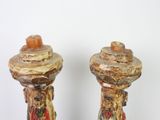 two candles that are sitting next to each other on a table