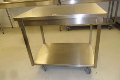 a stainless steel table with a drawer underneath it