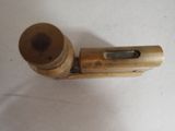 a small brass pipe that is sitting on a table