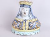 a ceramic figurine of a woman with a crown on her head