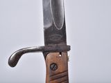 a knife that is sitting on top of a wooden stand