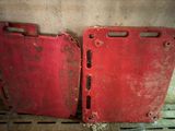 two pieces of red plastic sitting on the floor
