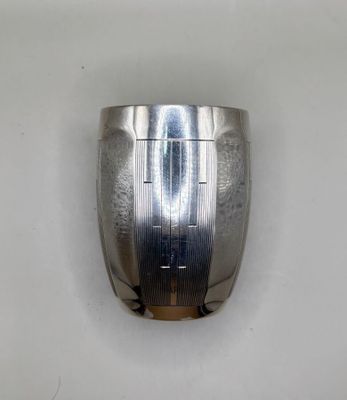 a close up of a metal object on a white surface